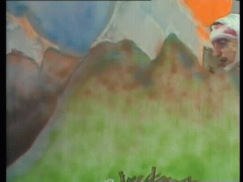 A Man Stands In Front Of A Painting Of A Mountain GIF