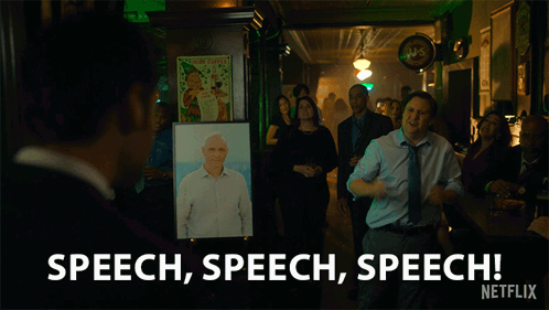 A Man Stands In Front Of A Picture Of A Man And Says Speech Speech Speech Netflix GIF