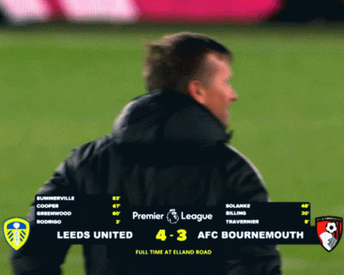 A Man Stands In Front Of A Scoreboard For A Premier League Game GIF
