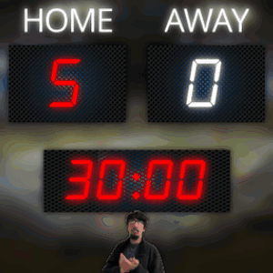A Man Stands In Front Of A Scoreboard That Reads Home 5-0 Away 0 GIF