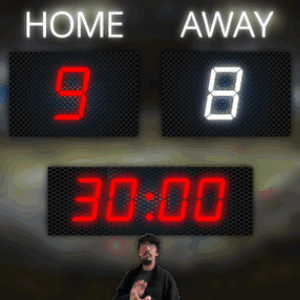 A Man Stands In Front Of A Scoreboard That Reads Home 98 Away 05:59 GIF