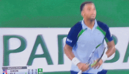 A Man Stands In Front Of A Scoreboard That Says " Match Point " GIF