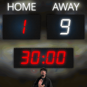 A Man Stands In Front Of A Scoreboard Which Says Home And Away GIF
