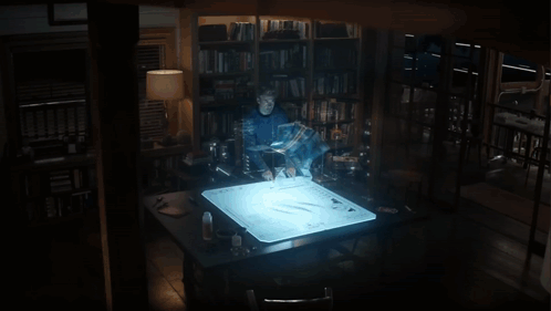 A Man Stands In Front Of A Screen That Says ' Avengers ' GIF