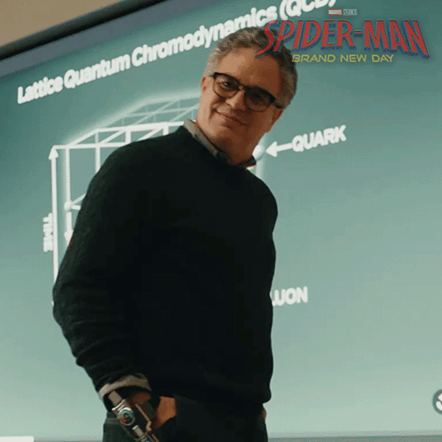 A Man Stands In Front Of A Screen That Says Spider-Man GIF