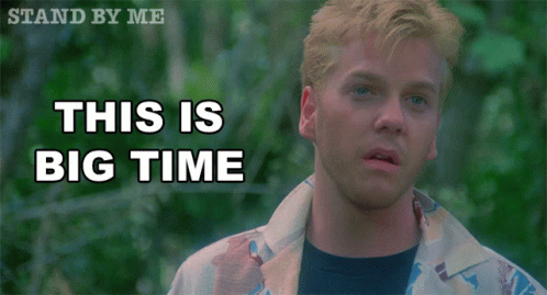 A Man Stands In Front Of A Sign That Reads This Is Big Time GIF