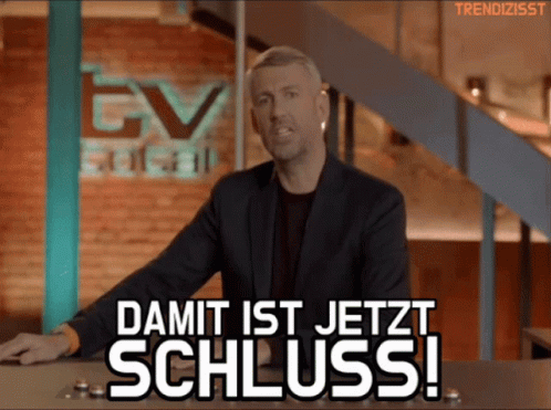 A Man Stands In Front Of A Sign That Says Damit Ist Jetzt Schluss ! GIF
