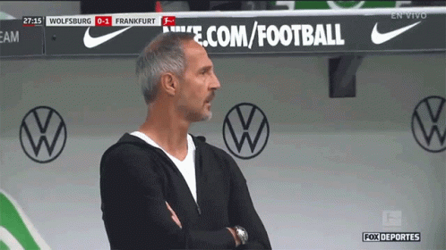 A Man Stands In Front Of A Sign That Says Ecom/football GIF