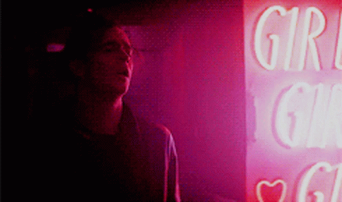 A Man Stands In Front Of A Sign That Says Girl GIF