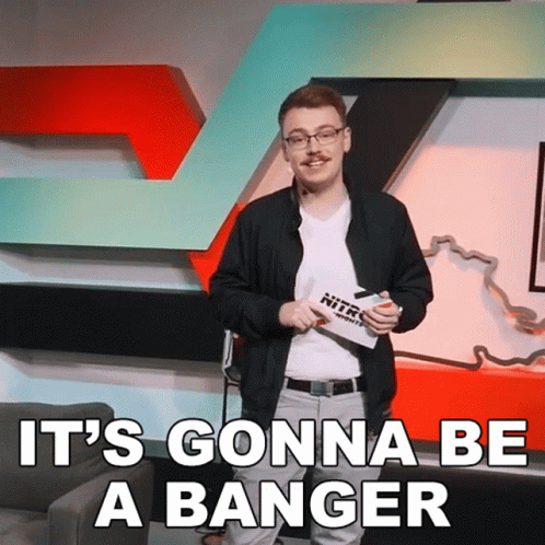 A Man Stands In Front Of A Sign That Says Nitro GIF
