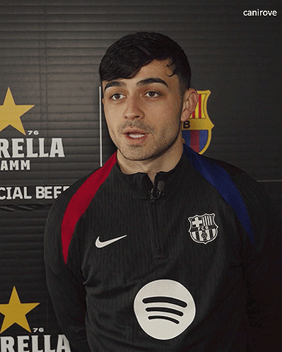 A Man Stands In Front Of A Sign That Says Rella GIF