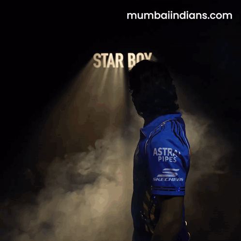 A Man Stands In Front Of A Sign That Says Star Boy On It GIF