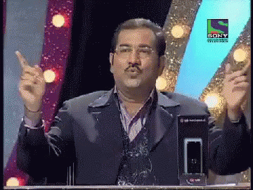 A Man Stands In Front Of A Sony Television Logo GIF