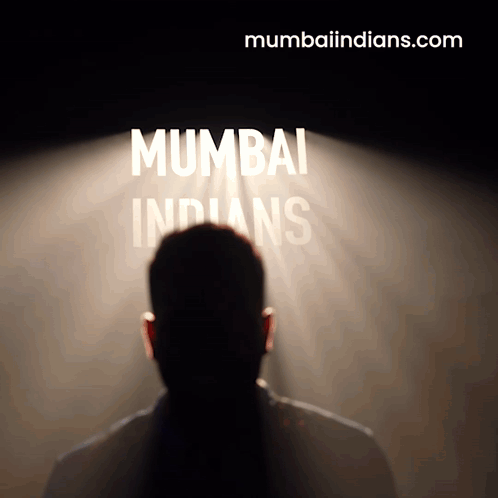 A Man Stands In Front Of A Spotlight That Says Mumbai Indians GIF