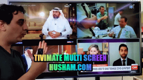 A Man Stands In Front Of A Tv Screen That Says Tivimate Multi Screen Husham.com On It GIF