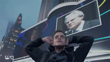 A Man Stands In Front Of A Usa Sign GIF