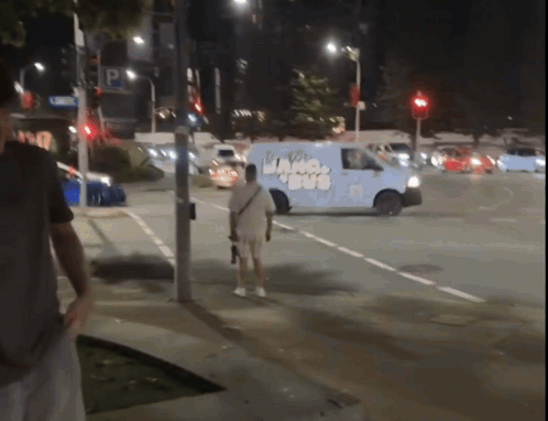 A Man Stands In Front Of A Van That Has The Word Ice Cream On The Side GIF