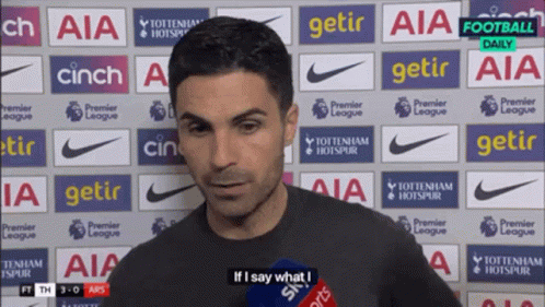 A Man Stands In Front Of A Wall That Says Aia GIF
