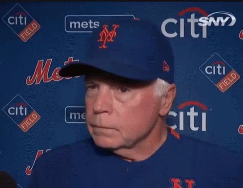 A Man Stands In Front Of A Wall With Citi Field Logos GIF