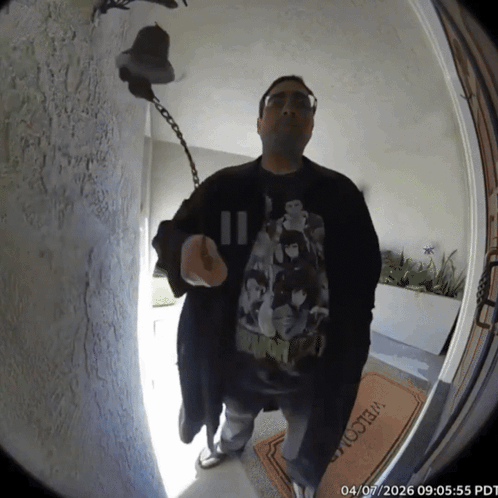 A Man Stands In Front Of A Welcome Mat GIF