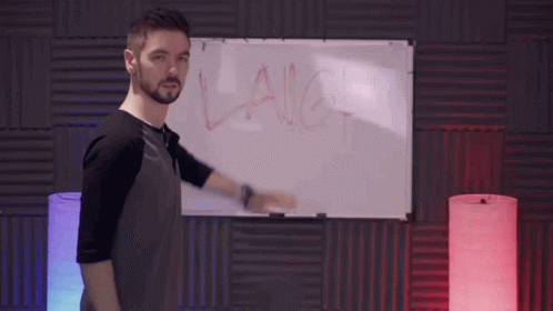 A Man Stands In Front Of A White Board With The Word Laugh Written On It GIF