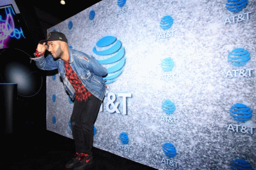 A Man Stands In Front Of An At & T Sign GIF