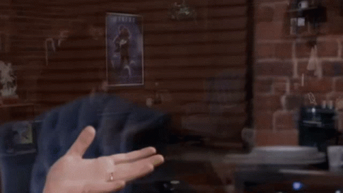 A Man Stands In Front Of An Atari Machine In A Room GIF
