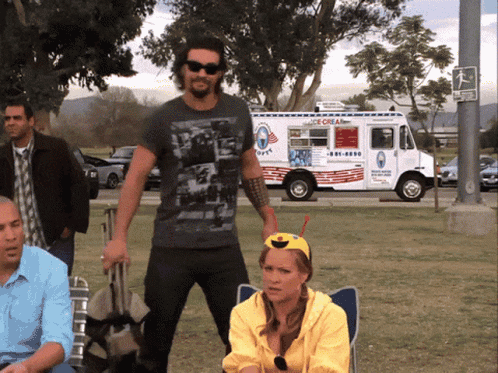 A Man Stands In Front Of An Ice Cream Truck That Says Ice Cream GIF