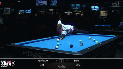 A Man Stands On A Pool Table In Front Of A Screen That Says Us Open On It GIF