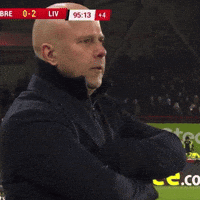A Man Stands On A Soccer Field With A Scoreboard Behind Him That Says Liv GIF