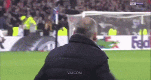 A Man Stands On A Soccer Field With The Word Valcom On The Bottom Right GIF