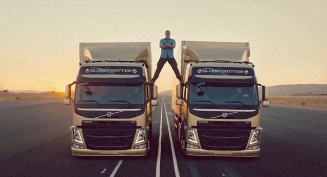a man stands on the roof of a volvo truck