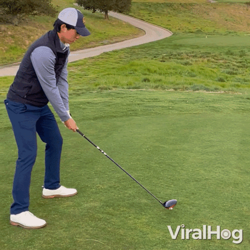 A Man Swinging A Golf Club On A Golf Course With Viralhog Written On The Bottom Right GIF