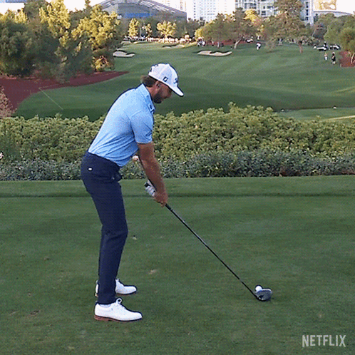 A Man Swings A Golf Club On A Golf Course With Netflix Written On The Bottom GIF