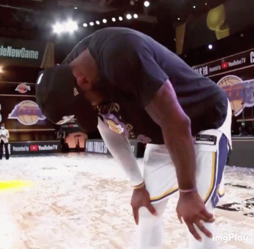 A Man Taking A Break On A Basketball Court With A Youtube Tv Banner In The Background GIF