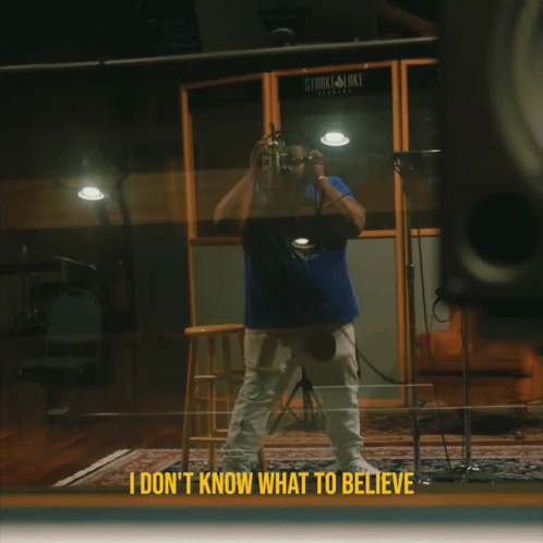 A Man Taking A Picture In Front Of A Stark & Luke Recording Studio GIF