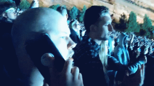 A Man Taking A Picture Of A Crowd With A Cellphone GIF