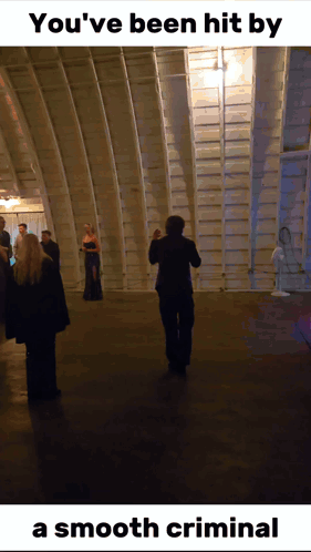 A Man Taking A Picture Of A Group Of People With The Caption " You 'Ve Been Hit By A Smooth Criminal " At The Bottom GIF
