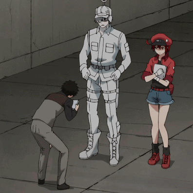 a man taking a picture of a man in a white uniform and a woman in a red uniform
