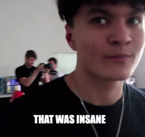 A Man Taking A Picture Of Another Man With The Words That Was Insane Above Him GIF