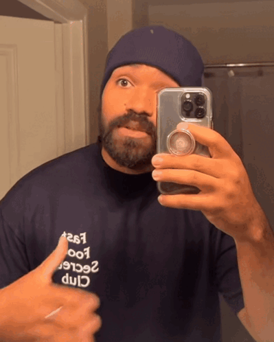 A Man Taking A Picture Of Himself In A Mirror GIF