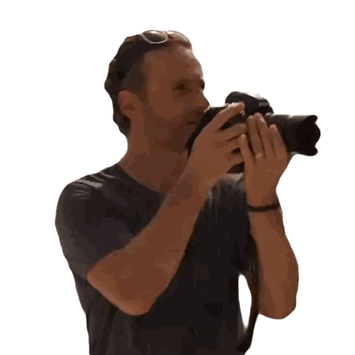 a man taking a picture with a camera that says nikon