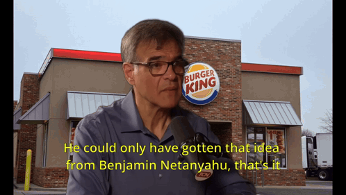 A Man Talking In Front Of A Burger King GIF
