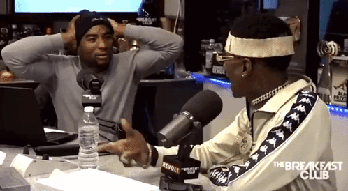 A Man Talking Into A Microphone With The Breakfast Club Written On The Side GIF
