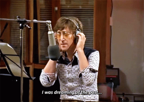 A Man Talking Into A Microphone With The Words " I Was Dreaming Of The Past " Below Him GIF