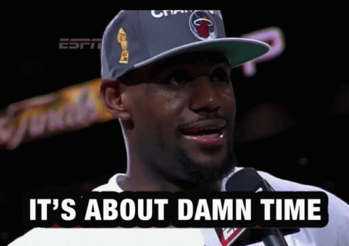 A Man Talking Into A Microphone With The Words " It 'S About Damn Time " Below Him GIF