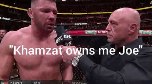 A Man Talking Into A Microphone With The Words " Khamzat Owns Me Joe " GIF
