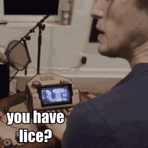 a man talking into a microphone with the words " you have lice " on the screen