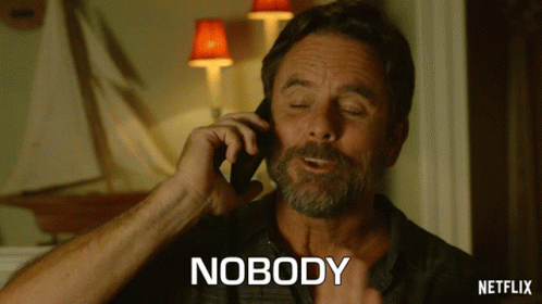 a man talking on a cell phone with the word nobody written below him