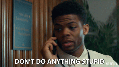 A Man Talking On A Cell Phone With The Words " Do N't Do Anything Stupid " Written Below Him GIF